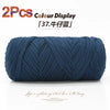 A skein of dark blue elastic yarn used for crafting.