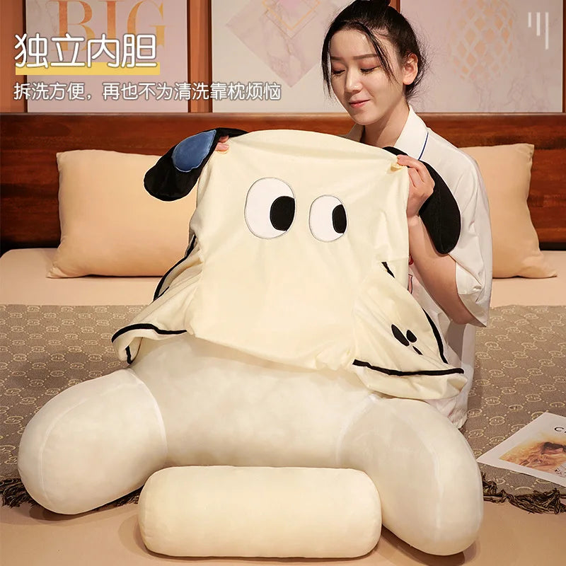A person is holding a large, cream-colored animal plush sofa cushion with black ears and features.