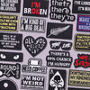 A collection of black and yellow embroidered slogan patches featuring various phrases like I'm broken and I'm kind of a big d