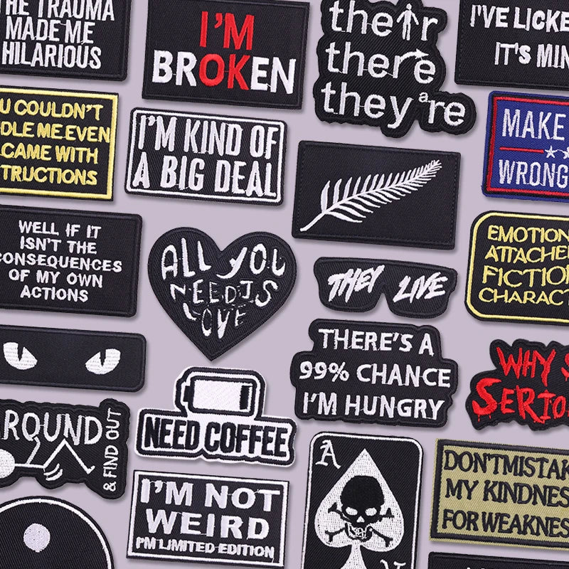 A collection of black and yellow embroidered slogan patches featuring various phrases like I'm broken and I'm kind of a big d