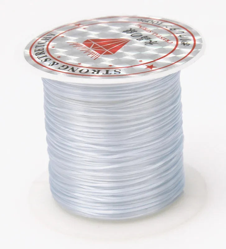 A spool of multicolor elastic beading cord with a circular label featuring Japanese text and a red diamond design.