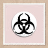 A black biohazard symbol pin on a light pink background inside a white frame.