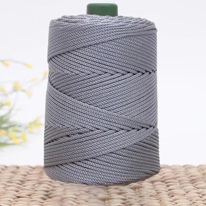 Gray 3mm ice rope crochet yarn wound tightly on a spool.