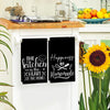 Two black kitchen towels featuring the text The kitchen is the heart of the home and Happiness Homemade