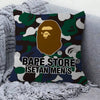 A decorative pillow cover featuring a camouflage pattern with a stylized lion's head and the text BAPE STORE ISETAN MEN'S