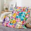 A colorful flannel blanket featuring a floral print with various teddy bears and flowers.