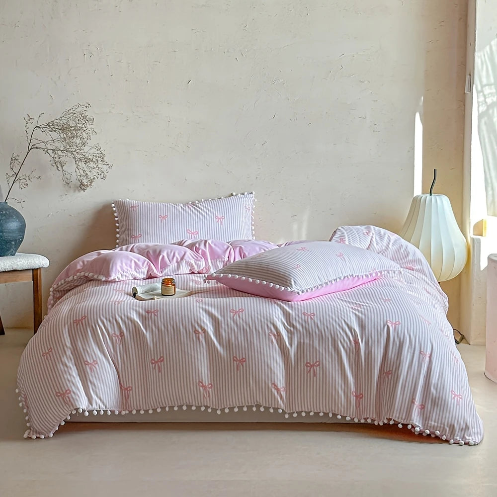 A pink striped quilt duvet set with matching pillowcases featuring a delicate pink bow print.