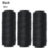 Three black spools of sewing thread for hair extensions