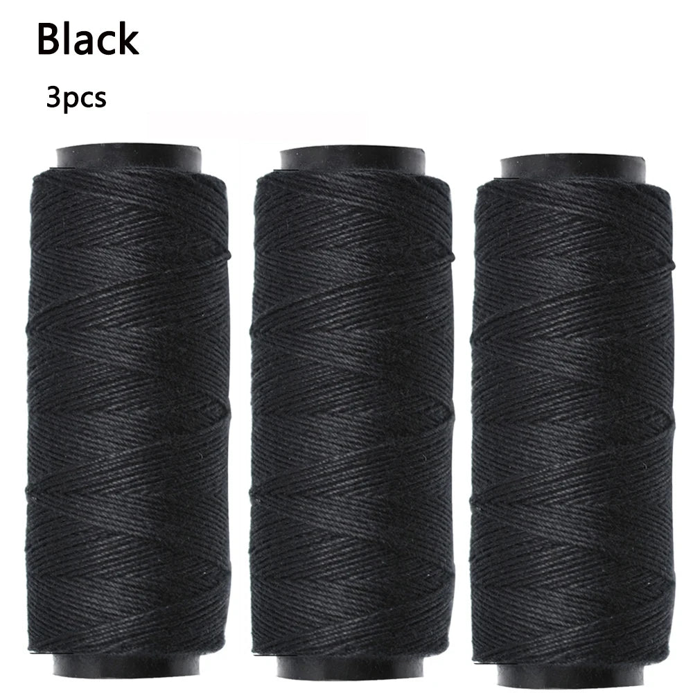 Three black spools of sewing thread for hair extensions