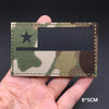A rectangular tactical patch featuring a camouflage pattern with a black star and a dark rectangular insert.