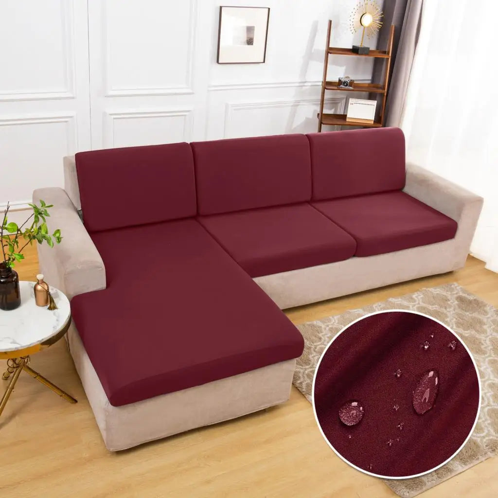 A deep burgundy waterproof sofa cushion protector cover on a beige sofa.