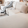A light beige removable jacquard seat cushion cover draped over a cream sofa with neutral pillows.