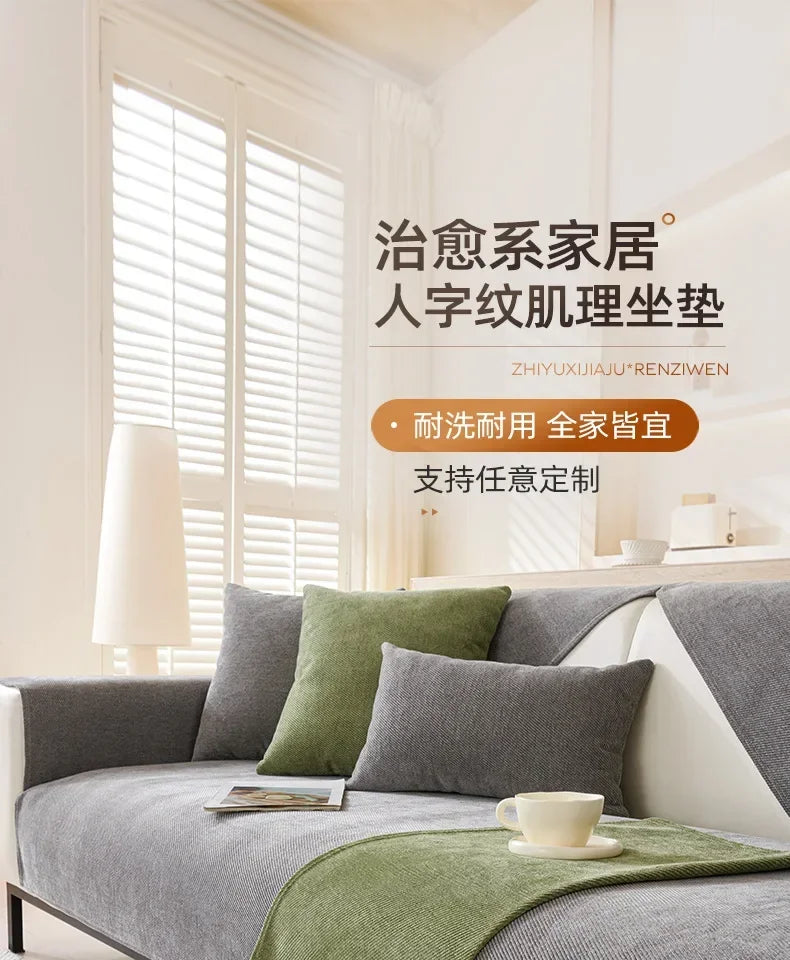 A light gray sofa with olive green cushions and a matching throw, displayed in a bright room.