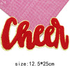 Red embroidered cheer letter iron-on patch on a pink grid background