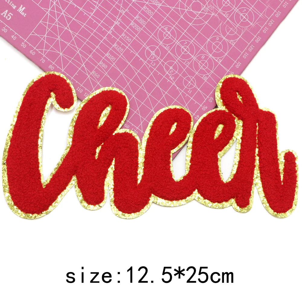 Red embroidered cheer letter iron-on patch on a pink grid background