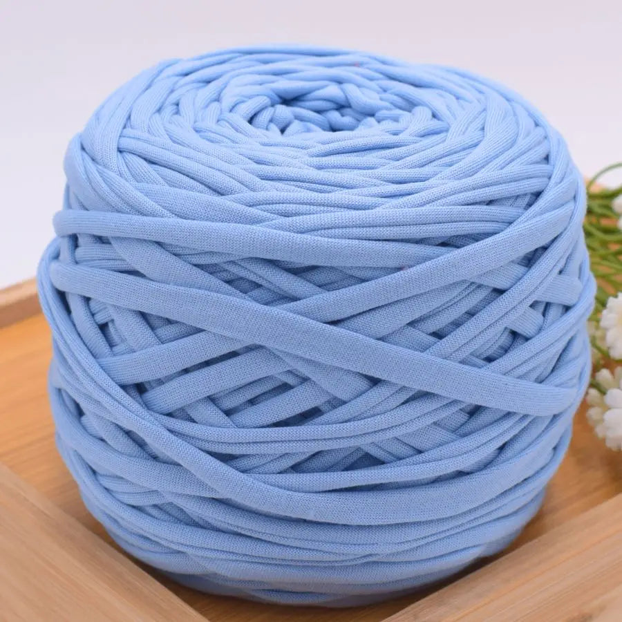 A ball of light blue craft yarn made of 100% polyester for knitting and DIY projects.