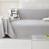 A light gray sofa covered with a textured, anti-slip Chenille fabric and a white decorative pillow.