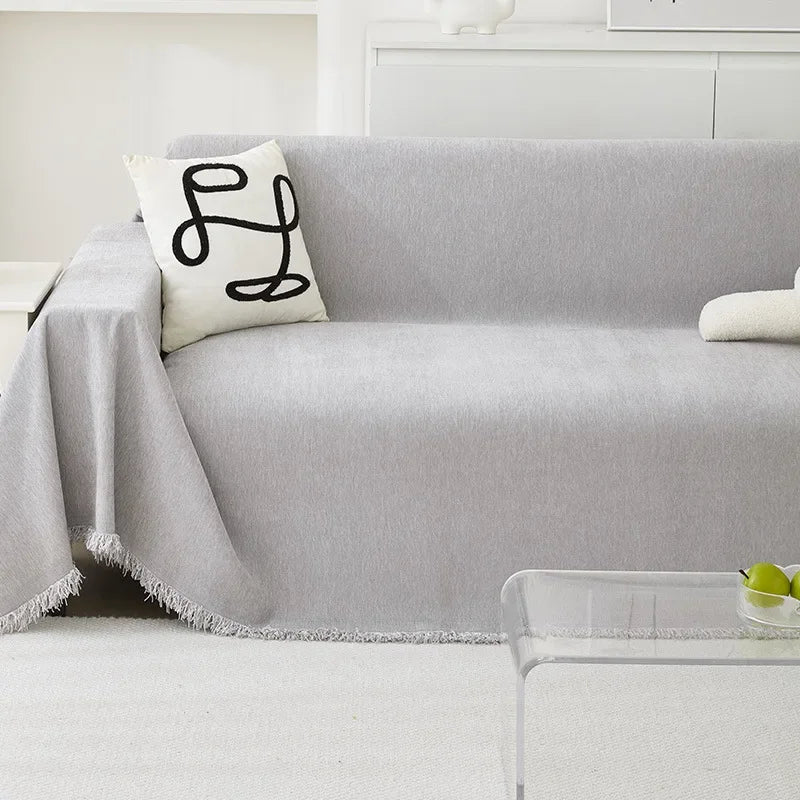 A light gray sofa covered with a textured, anti-slip Chenille fabric and a white decorative pillow.