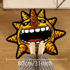A funny sun motif floor mat featuring an orange and black stylized sun face, shown from above.