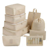 A set of beige travel storage organizers including a box, pouches, and cosmetic bags.