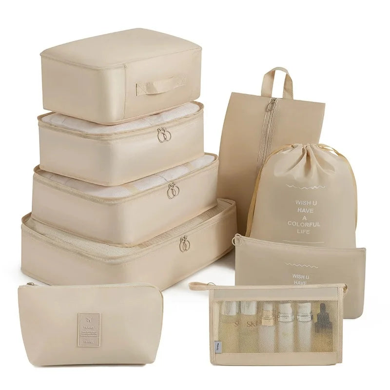 A set of beige travel storage organizers including a box, pouches, and cosmetic bags.