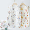 A white quilted baby sleeping bag with floral embroidery is displayed on a wooden hanger.