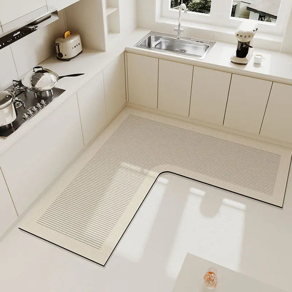A rectangular beige anti-slip floor mat is placed on a white kitchen countertop.