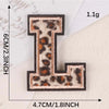 A black iron-on patch shaped like the letter L with a leopard print design.