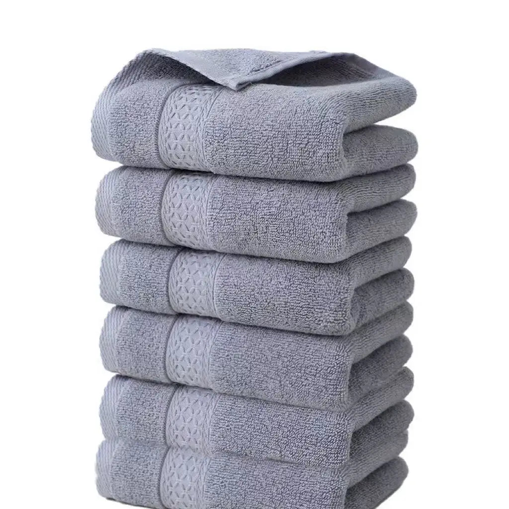 A stack of six gray textured face towels