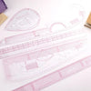 A set of precision sewing rulers and French curve templates for garment making.