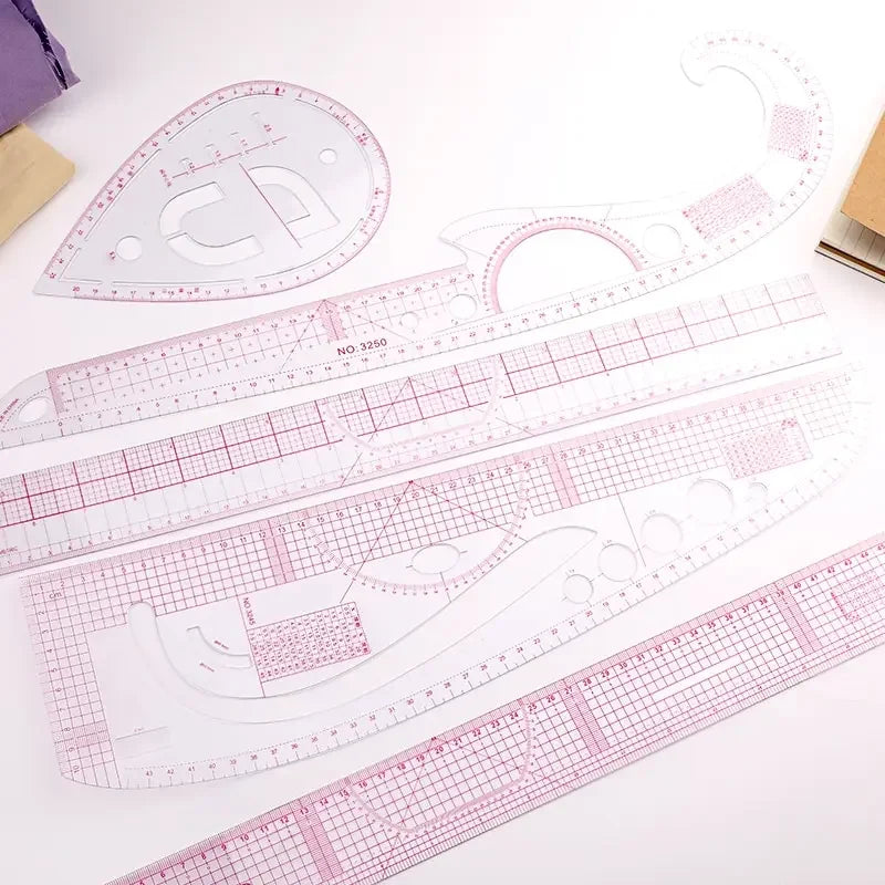 A set of precision sewing rulers and French curve templates for garment making.