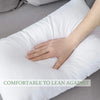 A hand rests on a white throw pillow insert with bounce-back support, demonstrating comfort to lean against.