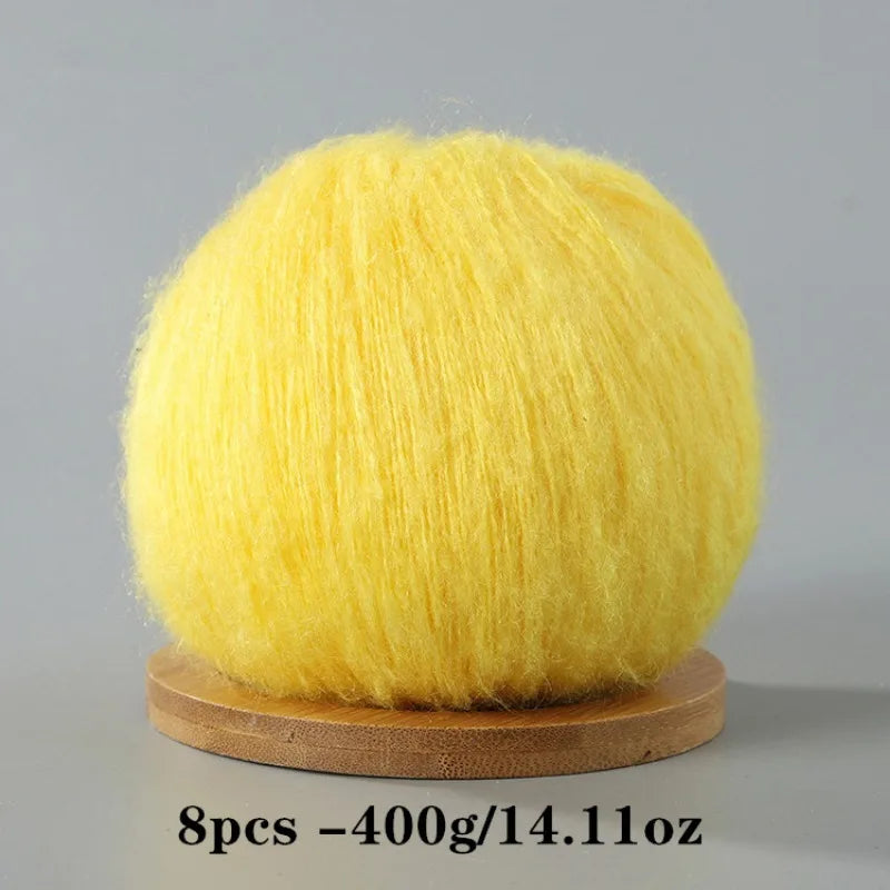 A ball of bright yellow mohair yarn used for crafting.