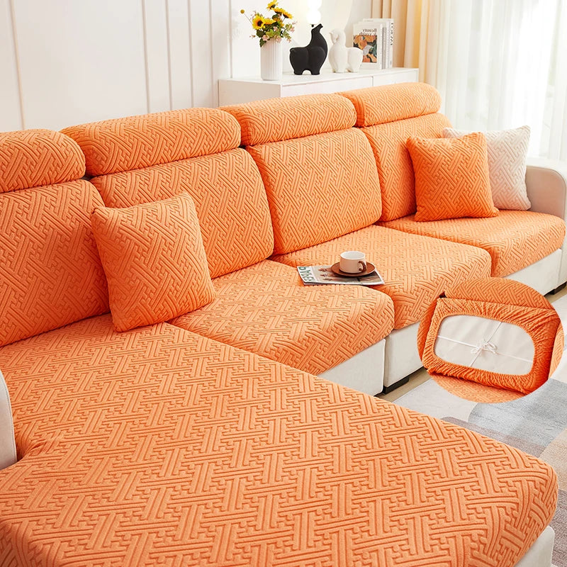 Orange jacquard plush sofa cushion cover with textured fabric and decorative pillows on a white sofa.