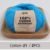 A ball of bright blue 100% organic cotton yarn labeled QJH for knitting and crochet