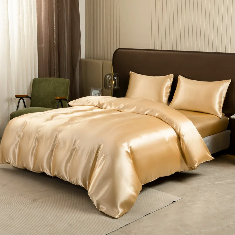 A luxurious satin gold bedding set on a bed with dark brown upholstery and light neutral decor.