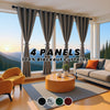 A set of four gray blackout curtains hanging in a window with a modern living room setting.