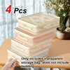 Four stacked clear storage bags for bedding and blankets shown on a wooden surface.
