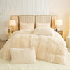 A fluffy cream plush duvet cover set displayed on a bed with upholstered headboards and bedside lamps.