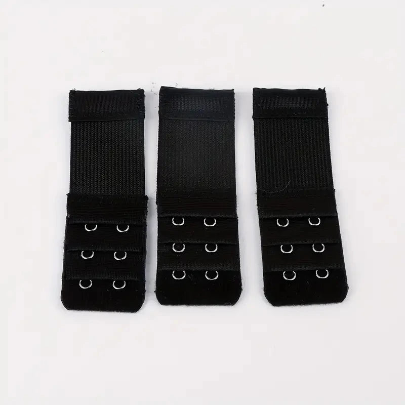 Three black adjustable bra extender straps laid out side by side.