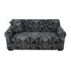 A black stretchable festive sofa cover with an ornate skull and floral pattern.