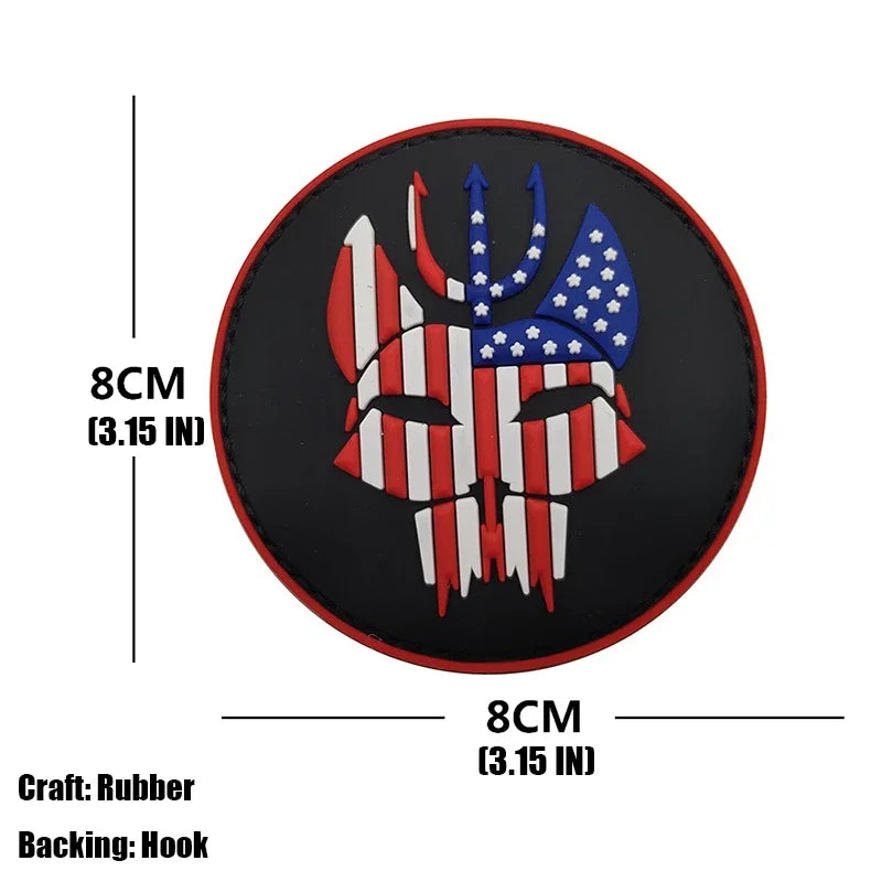 A round black rubber armband patch featuring a stylized eagle head with American flag elements embroidered in red, white, and
