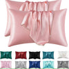 A collection of pink, red, black, and blue satin silk pillow covers for hair and beauty.