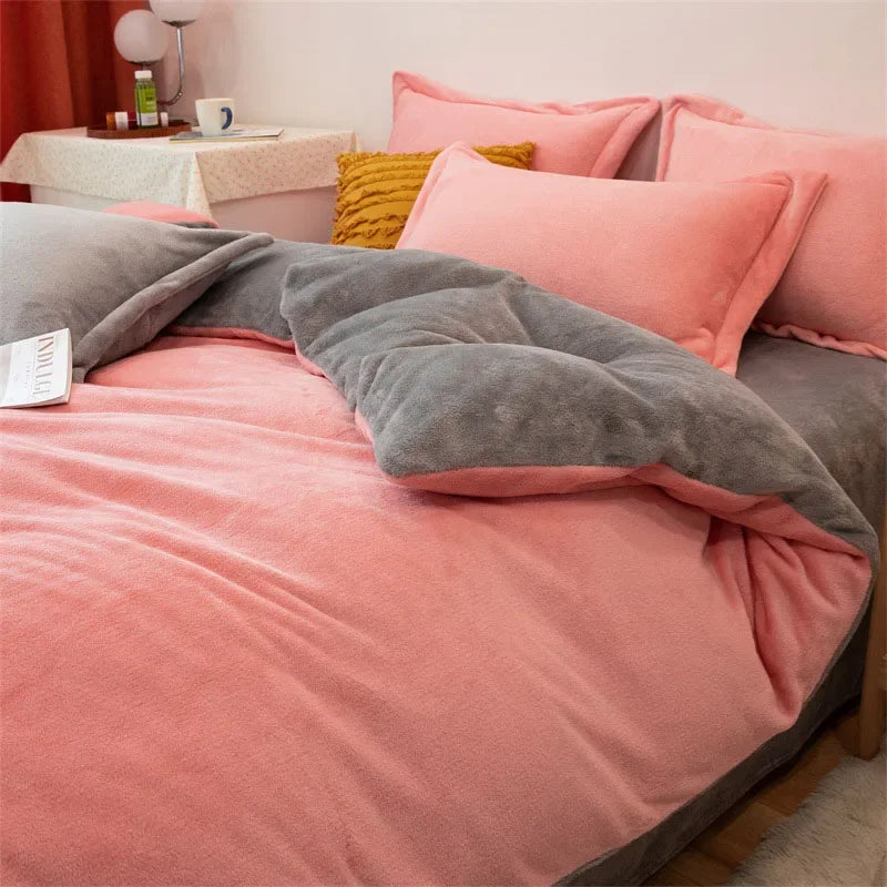 A pink and gray duvet cover set featuring a soft flannel texture with matching pillows and a throw blanket.