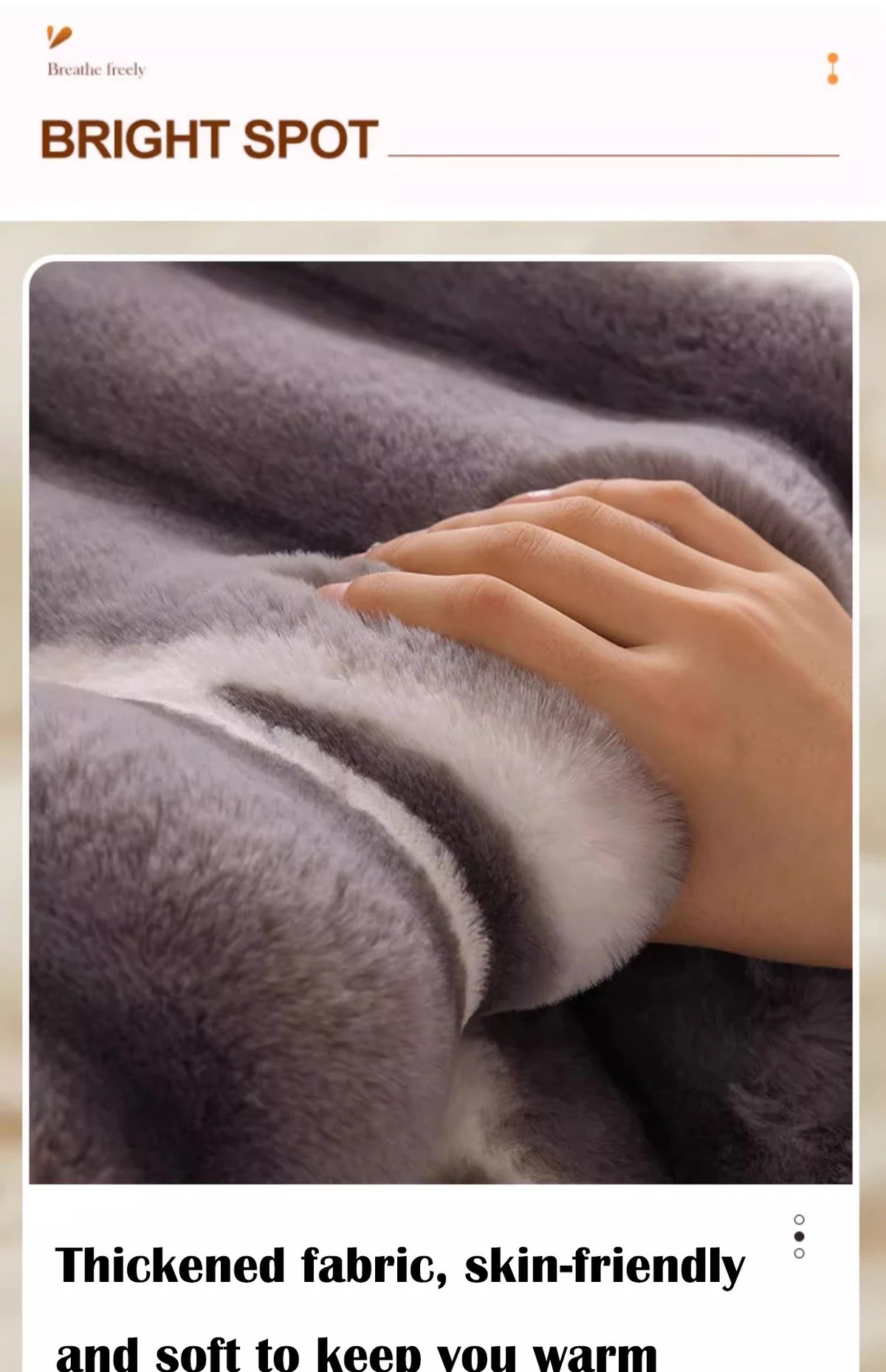 A hand gently touches a thick, gray plush velvet fabric, highlighting its soft texture and warmth.