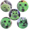 A set of five tinplate pin brooches featuring green, stylized animal faces.