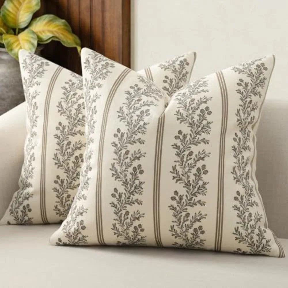 A vintage striped floral throw pillow cover with gray and green botanical patterns on a cream background.
