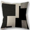 Abstract geometric pillow cover featuring black, beige, and gray textured squares.