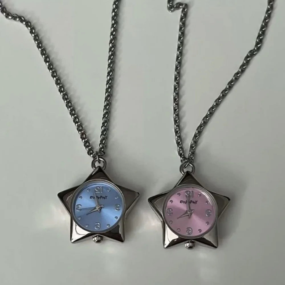 A silver chain necklace features a star-shaped pocket watch with a light blue dial and a pink dial.