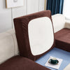 A close-up of a brown waterproof jacquard stretch sofa cover featuring a white cushion on a light blue surface.